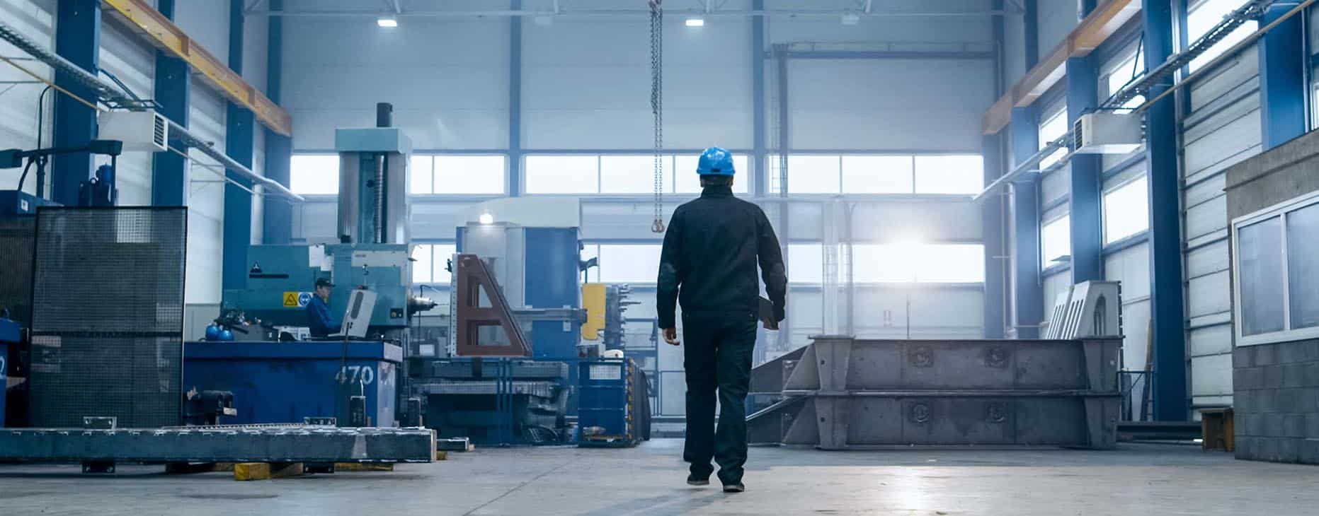 Man Wearing Protective Gear Walking Onsite — Fabrication & Engineering in Mackay, QLD