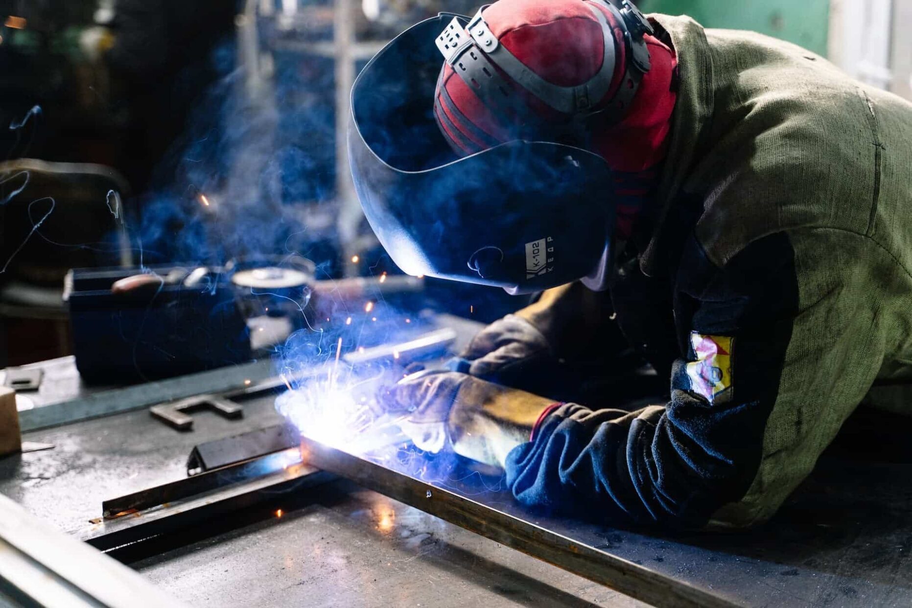 Man welding a piece of metal — Fabrication & Engine